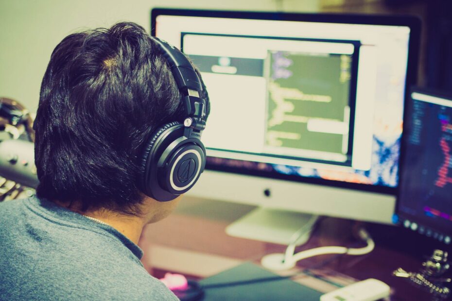 selective focus photography of man facing computer